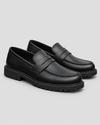 Black High Sole Strap Loafer — studio light grey background