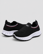 Women’s Knit Comfort Black Slip-On Sneakers — studio light grey background