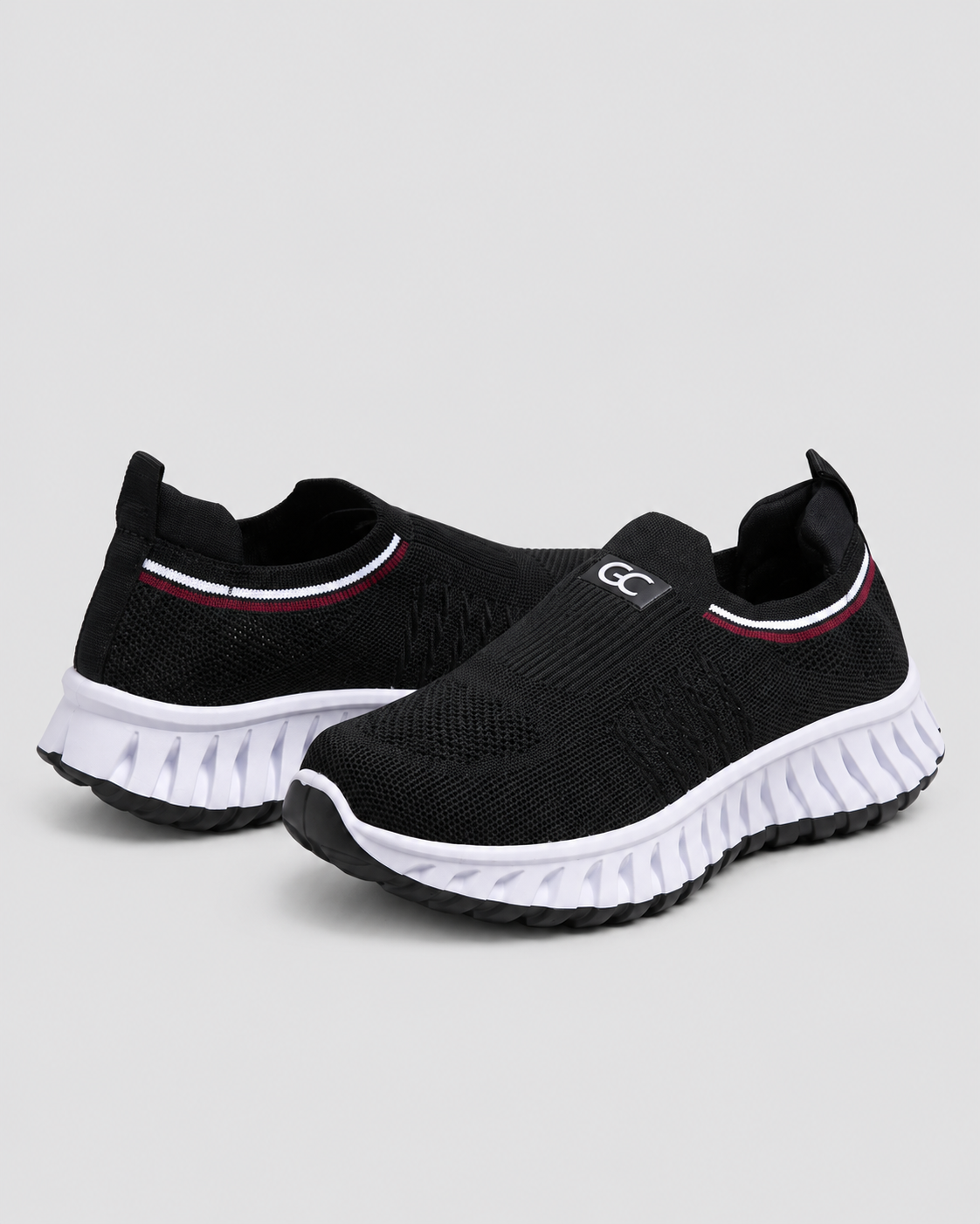 Women’s Knit Comfort Black Slip-On Sneakers — studio light grey background